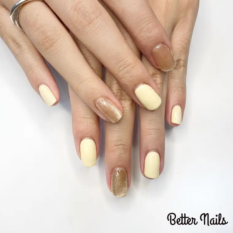Butter yellow gel with bronze glitter accent nails