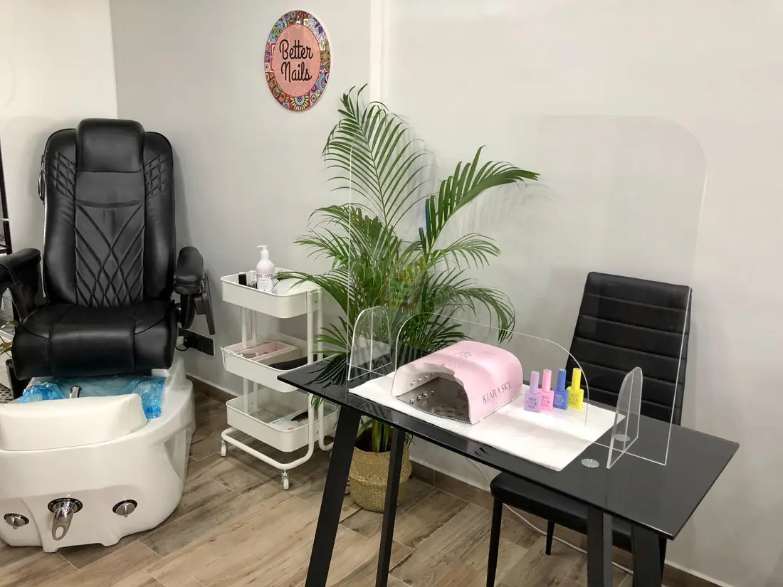 The Better Nails studio: pedicure spa chair, manicure table and a plant